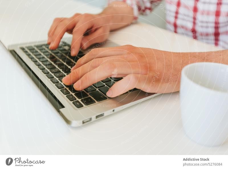 Crop man typing on a Modern Laptop business button close-up closeup computer computing desk equipment finger hand job keyboard keypad laptop occupation office