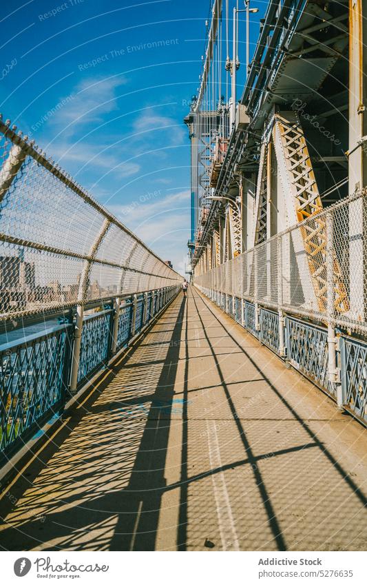 Sidewalk on bridge in sunny weather sidewalk water metal fence city landmark river sunlight tourism brooklyn bridge new york usa united states america