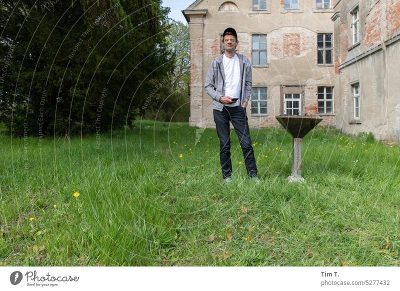 Man next to grill BBQ Mecklenburg-Western Pomerania Country house Farmhouse Historic pre-Pomerania MV