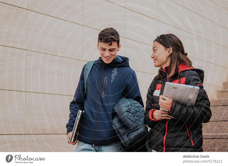 Cheerful students climbing up stairs together laptop study friend campus smile university positive young friendship cheerful college classmate group walk happy