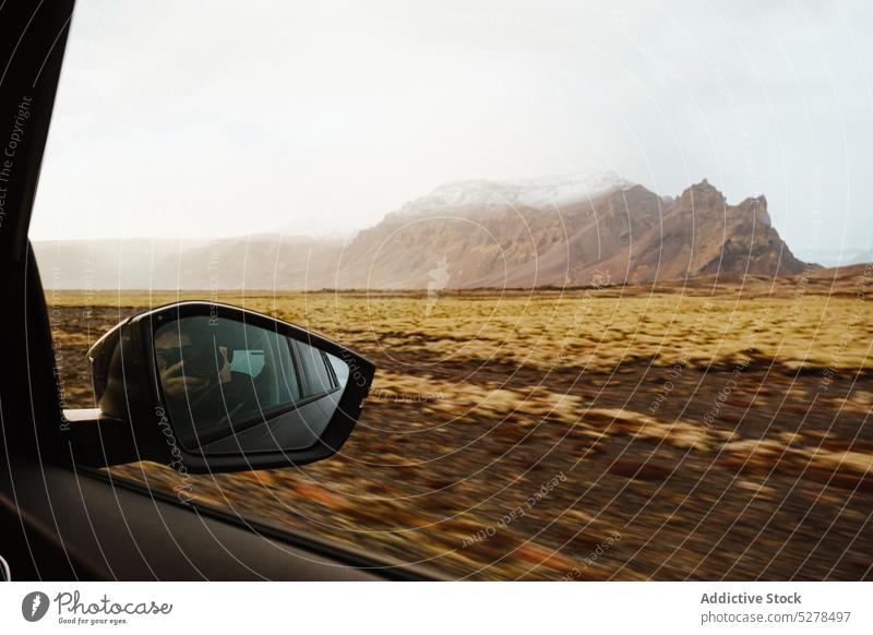 Side mirror during road trip car reflection sunshine mountain countryside drive travel sunrise iceland automobile highland route nature vehicle transport way