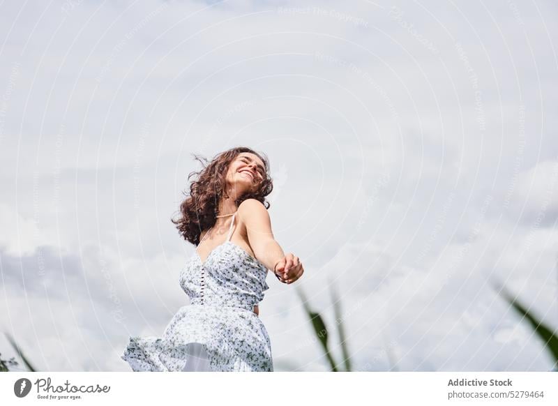 Cheerful woman dancing in field dance park smile summer happy countryside enjoy grass lawn rest female young cheerful sun relax carefree nature daytime positive