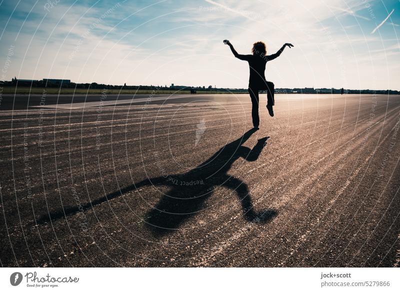 Nobel Peace Prize worthy* train posture and balance on the runway Posture On one leg Balance Flexible Leg lifted well-being harmony Practice Asphalt Shadow play