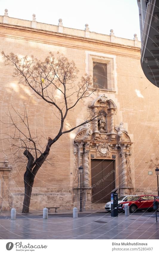 Historic building in Valencia. Museum stone building in beige colors with a tree silhouette and cars on the road. Building Architecture Wall (building) Facade