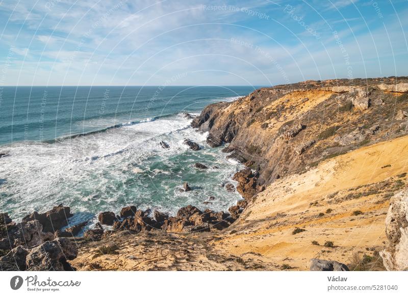 Limestone crumbling cliffs on the Atlantic coast Odemira region, western Portugal. Wandering along the Fisherman Trail, Rota Vicentina craggy majestic romantic