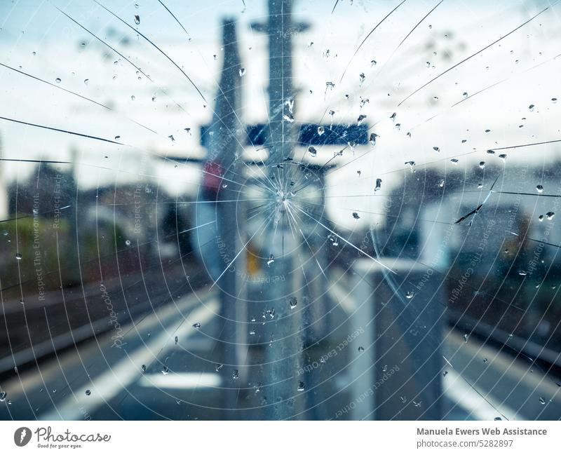 Close up of cracked glass pane at train station Local traffic Track Regional transport Railway station Stop (public transport) Broken defective disc Pane