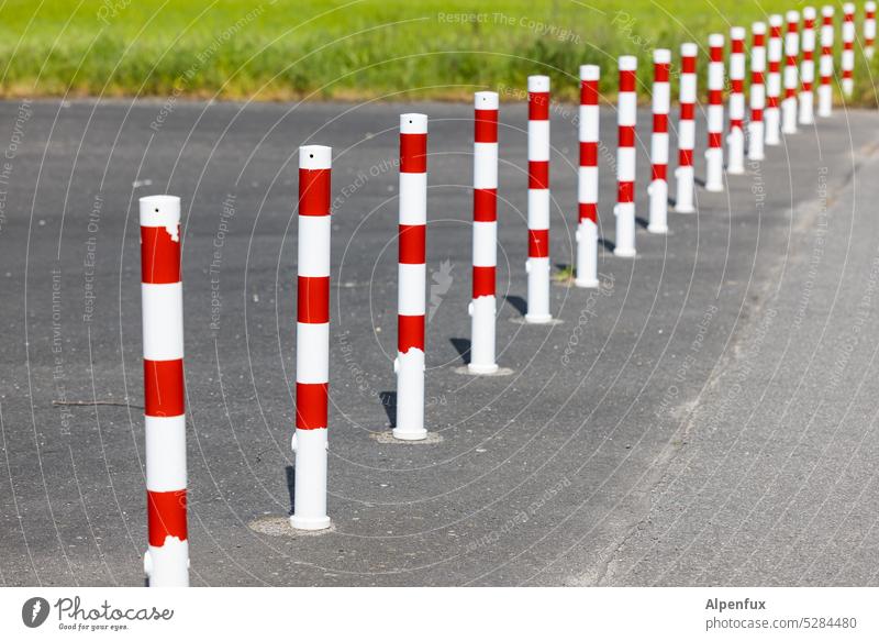 MainFux | Collection | red and white post Pole Striped cordon Safety Protection Exterior shot Structures and shapes Barrier Bans Reddish white Deserted Asphalt