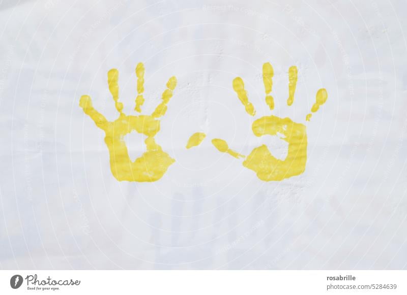 yellow imprint of two children's hands Hand Colour Finger paint Imprint handprint Child game Painting (action, artwork) Art Creativity Fingerprint