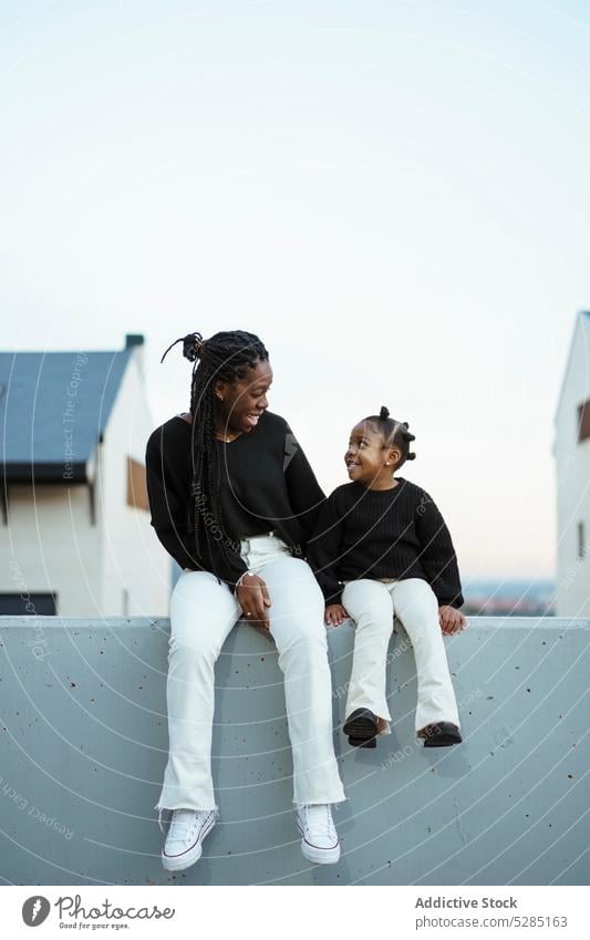 Happy African American mother and daughter on street woman girl having fun match bonding motherhood happy smile similar alike resemble female kid child black