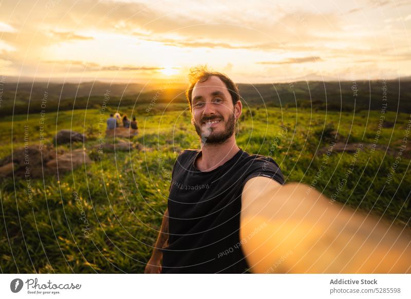 Happy man taking selfie during sunset tourist smile self portrait scenic sundown valley costa rica male take photo nature landscape summer travel trip vacation