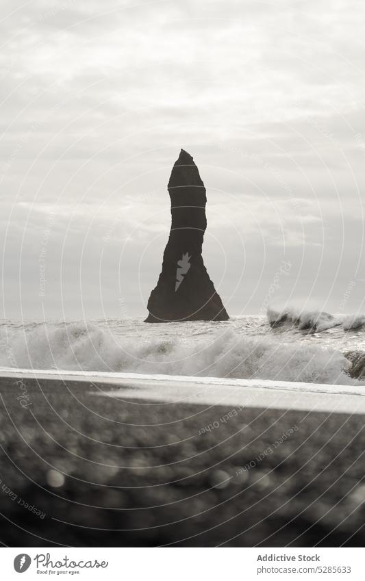 Waving sea with rocky formations seascape ocean wave cliff overcast stormy cloudy coast nature shore sky weather water gloomy iceland stone seashore