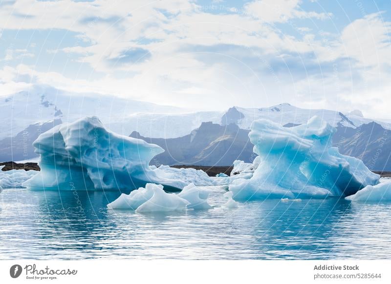 Icebergs in cold sea water iceberg winter formation dull weather frozen iceland ocean shore coast frost ripple season gray temperature north polar crystal