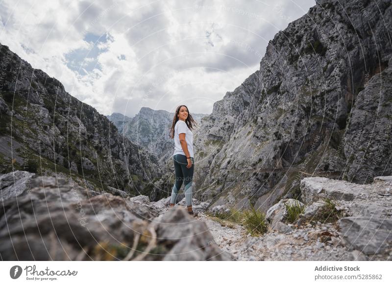 Cheerful woman enjoying freedom in mountains trekking hiker rocky traveler stone nature highland adventure spain slope asturias female scenery landscape happy