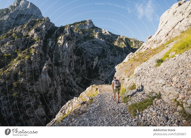 Unrecognizable traveler walking on mountain slope admire trip nature range landscape highland trekking backpack spain journey adventure tourism wanderlust