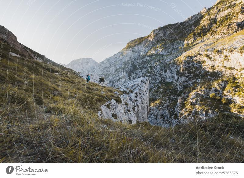 Traveler walking on mountain slope woman traveler admire trip nature range landscape highland trekking spain journey adventure tourism wanderlust vacation rocky