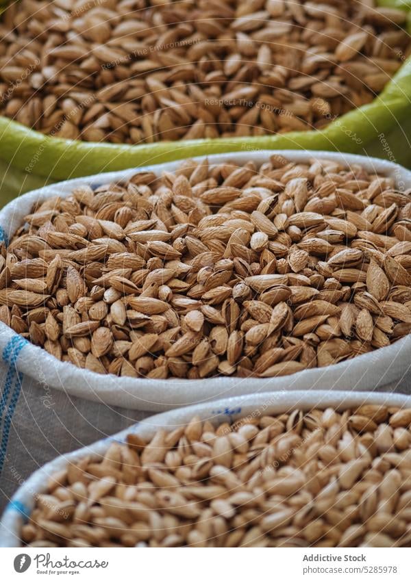 Stacked plastic bags with pistachios nut market stall sell food assorted pile healthy product delicious natural snack tasty raw various many organic heap