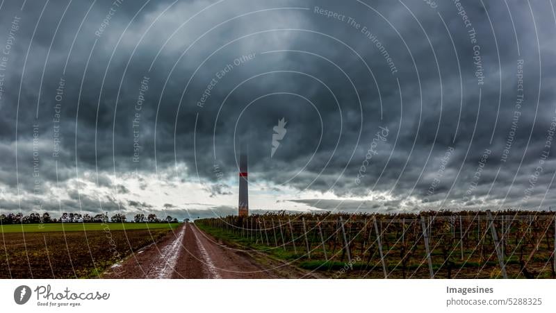 Storm. Storm over the vineyard. Dark clouds moving in, farmland with wind turbine. Thunderclouds move up Wind energy plant dark Clouds Arable land wind farm