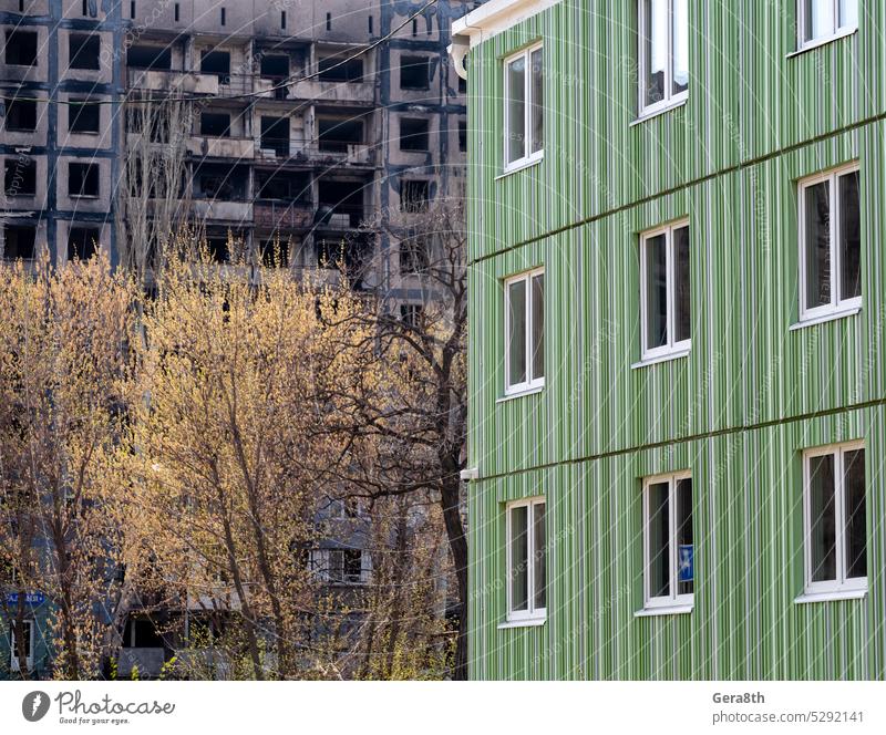 newly built house against the background of the destroyed and burned during the fighting in Ukraine Donetsk Kherson Kyiv Lugansk Mariupol Russia Zaporozhye