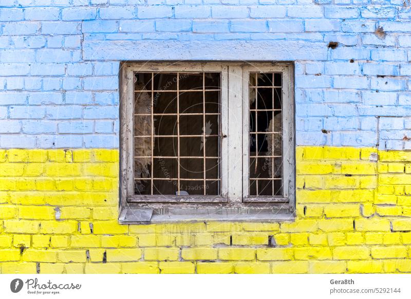 pattern explosion damaged blue yellow house wall with window in Ukraine Donetsk Kherson Kyiv Lugansk Mariupol Russia Zaporozhye abandon abandoned attack