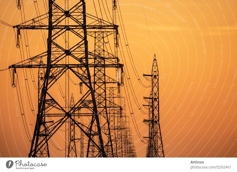 High voltage electric transmission tower. High voltage power lines on electric pylon against a sunset sky. Electrical infrastructure. Energy crisis. Electric power distribution. Energy distribution.