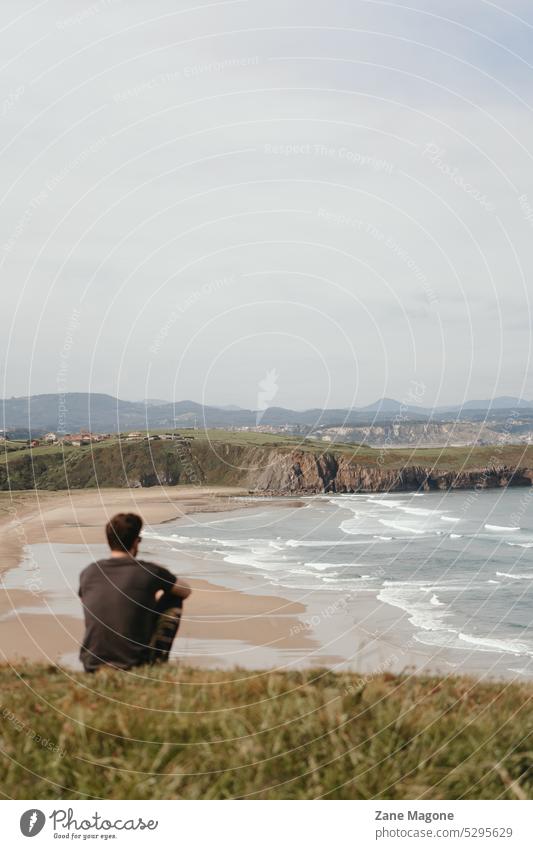 Man looking at ocean coast, Playa de Xagó, Spain ocean beach spain asturias Coast coastline sea playa landscape nature travel Ocean tourism water Summer