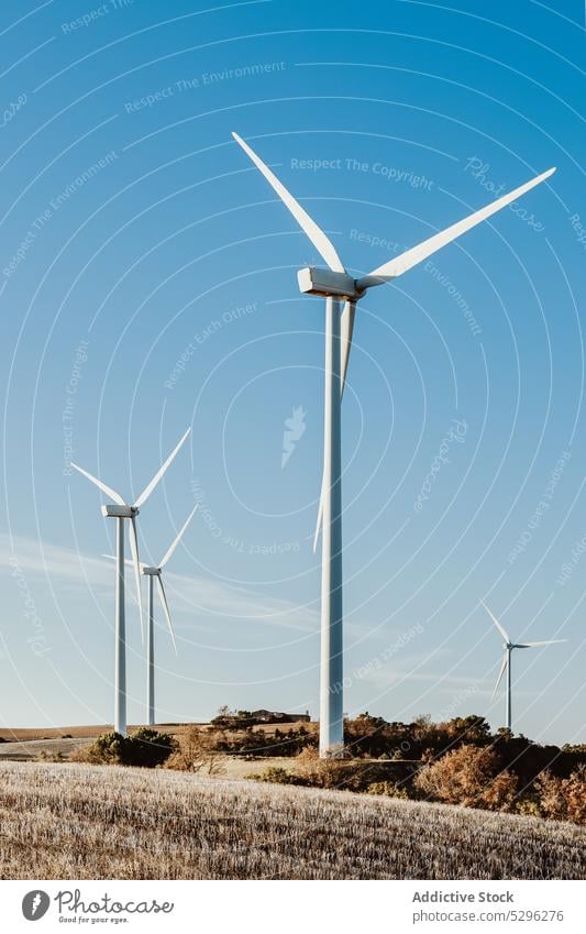 Wind turbine against blue cloudless sky wind alternative energy blue sky generator ecology production resource power environment sustainable propeller rotate