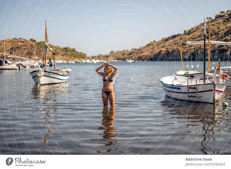 Woman in bikini near yachts admiring view woman tourist boat sea relax vacation cadaques beach admire female girona spain travel adventure ocean coast bay