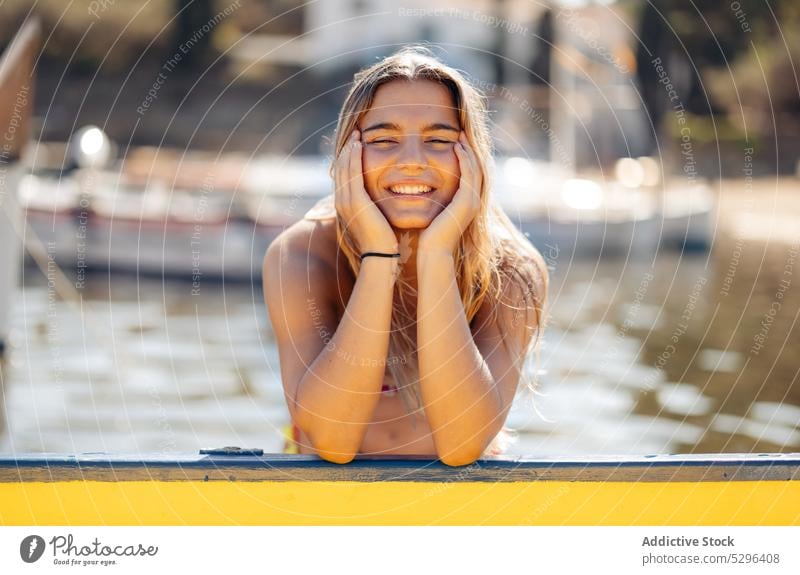 Positive woman chilling on yacht in port traveler boat rest summer weekend girona female spain cadaques beach tourism cheerful adventure ocean sea coast