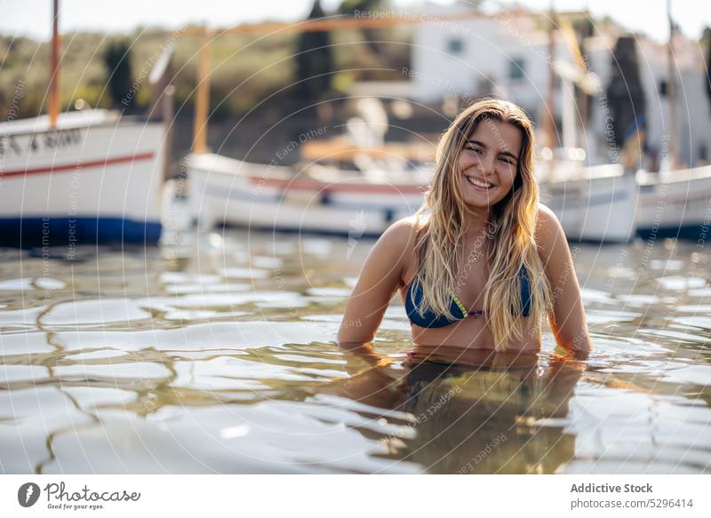 Happy woman in bikini near yachts admiring view tourist boat sea relax vacation cadaques beach admire female girona spain travel adventure ocean coast bay