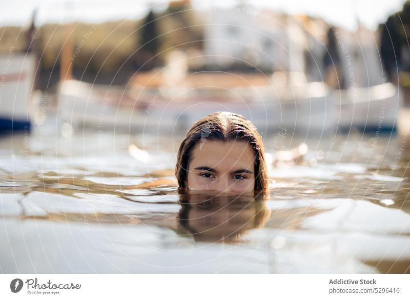 Woman diving in port with boats woman dive dip swim chill calm summer vacation girona female spain cadaques beach travel tourism adventure freedom ocean sea