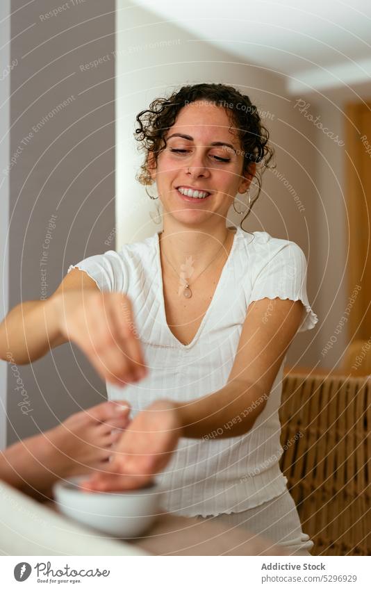 Woman masseuse applying body oil on back of female client during massage women therapy relax spa pour wellness body care rehabilitation aromatherapy procedure