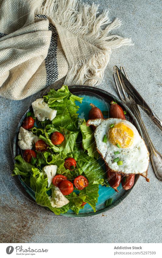 Lunch with salad and sausages breakfast egg food lunch American German background cheese cherry tomato concrete cooking cutlery diet dinner dinnerware eat