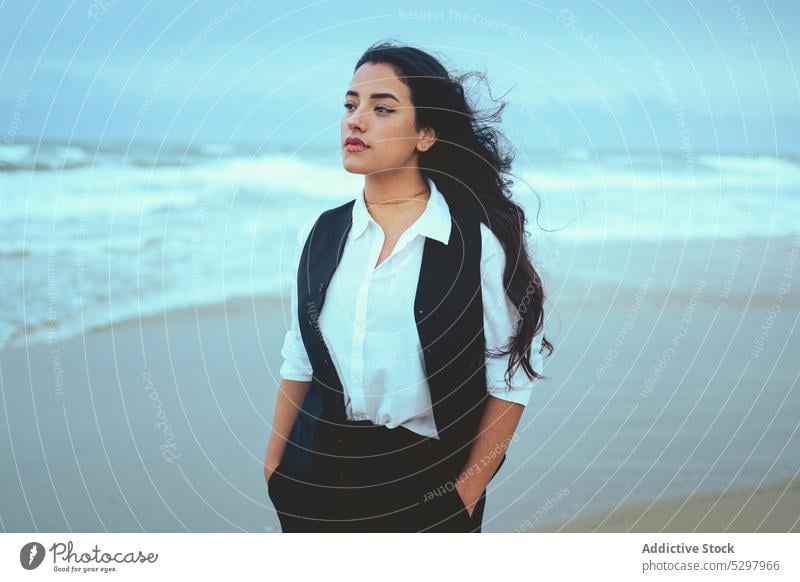 Pensive woman with hands in pockets on beach sea pensive seashore ocean thoughtful calm coast female sand wave nature wind water hand in pocket seaside rest