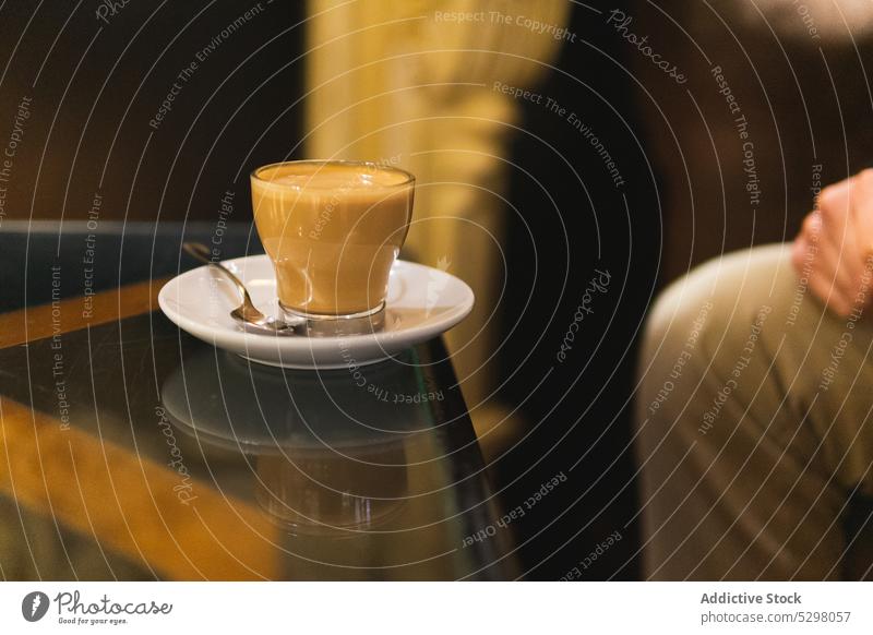 Unrecognizable person sitting at table with coffee cafe americano cream black coffee cup drink glass beverage enjoy fresh aroma rest caffeine delicious aromatic