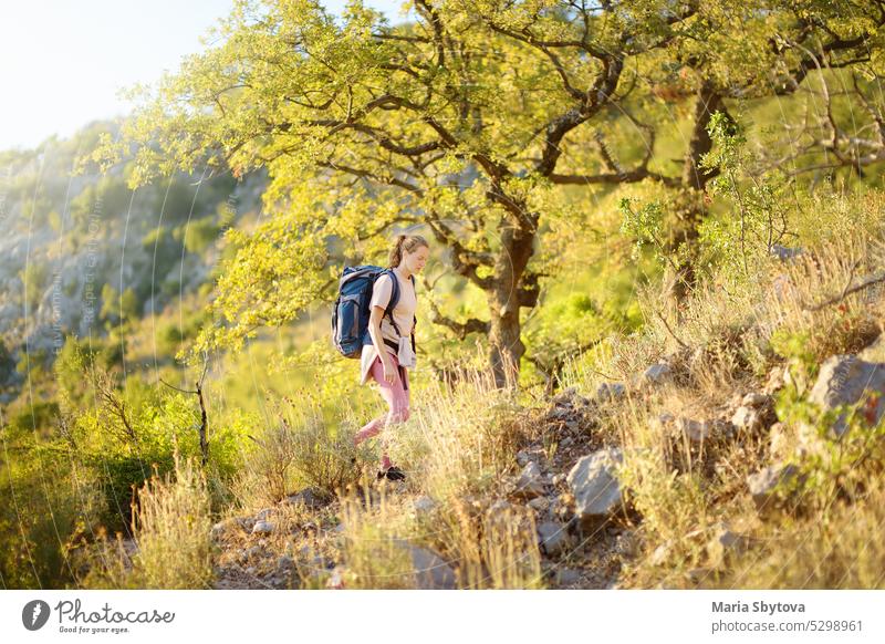 Young woman hiking in countryside. Concepts of adventure, extreme survival, orienteering. Backpacking hike young mountain europe autumn backpacking mountaineer