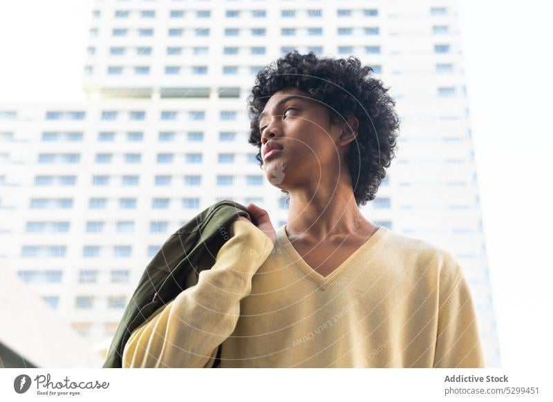 Thoughtful ethnic man with Afro hairstyle on street cool pensive thoughtful afro building modern urban trendy young serious male contemporary contemplate