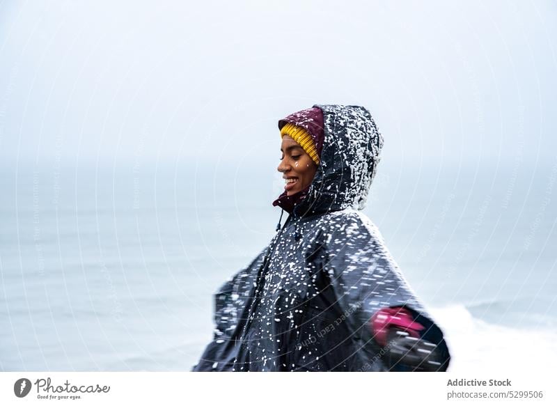 woman tourist in raincoat covered with snow traveler hoodie vacation explore admire nature sky stormy idyllic weather cloudless wanderlust alone harmony tourism