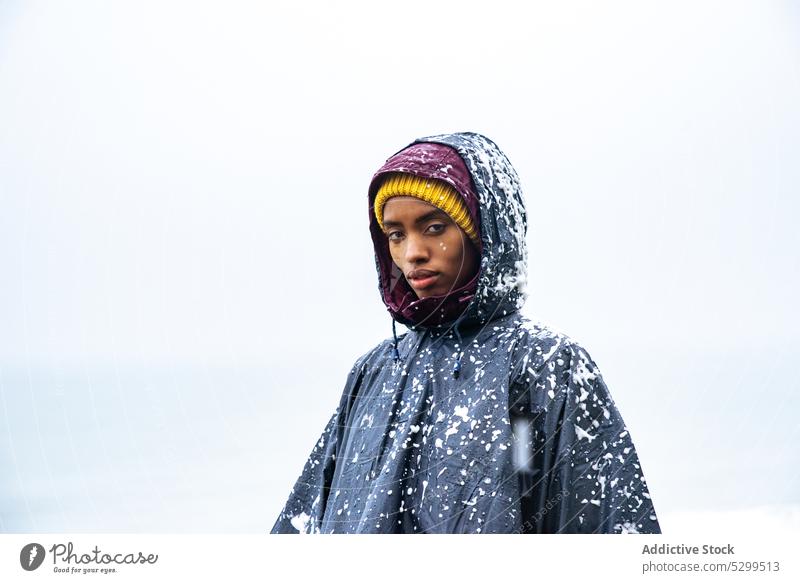 Female traveler in raincoat near ocean woman serious sea beach foam portrait cover tourism nature seashore female coast young vacation seaside tourist