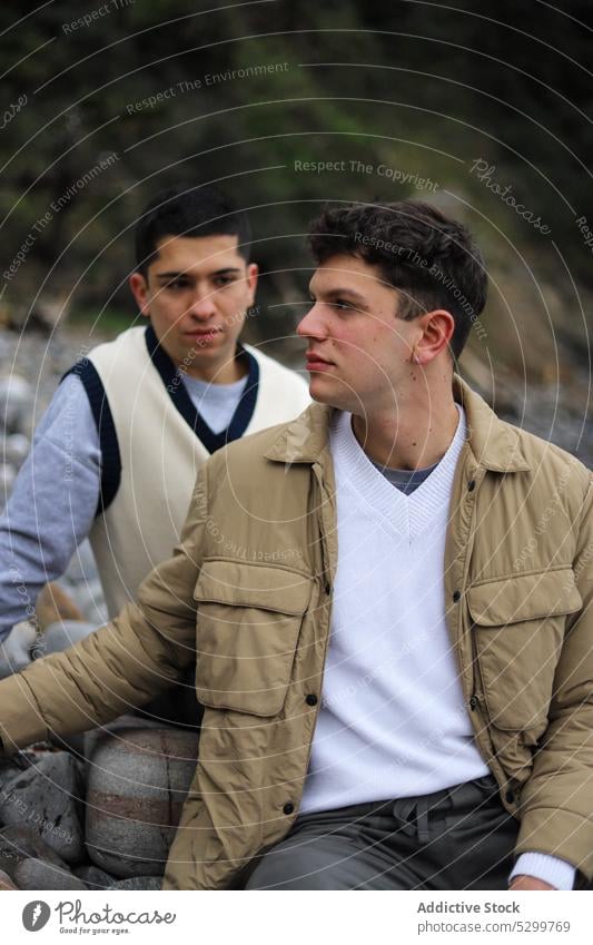 Gay couple sitting on rocks gay love homosexual boyfriend in love relationship lgbt young together spend time bonding soulmate idyllic beloved tolerance tender