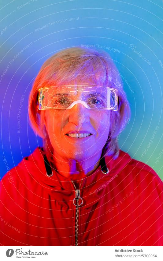 Confident senior woman in glasses neon hipster beard portrait serious style confident illuminate male elderly light pensive mature bright modern glow