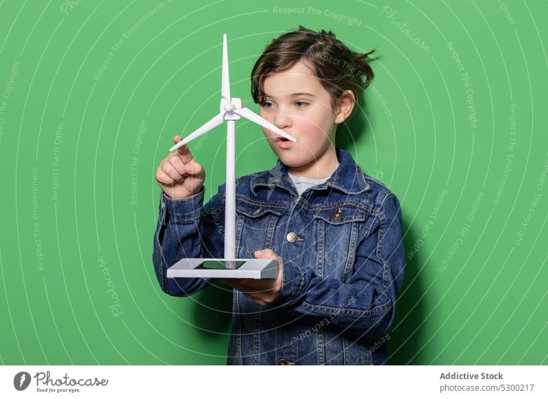 Smiling kid with windmill mockup girl child happy power energy eolic generator preteen focus casual cheerful renewable alternative energetics smile joy