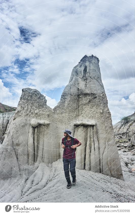 Happy man walking in rocky canyon traveler desert hike smile cheerful happy spectacular picturesque breathtaking colombia admire male tatacoa tourism adventure