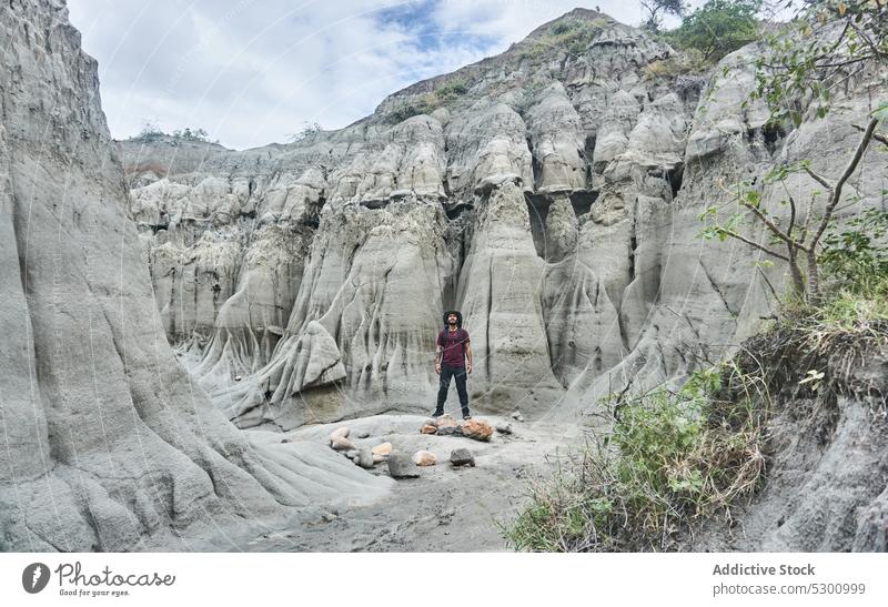 Man standing in rocky canyon man traveler desert hike spectacular picturesque breathtaking colombia admire male tatacoa tourism adventure trip explore observe