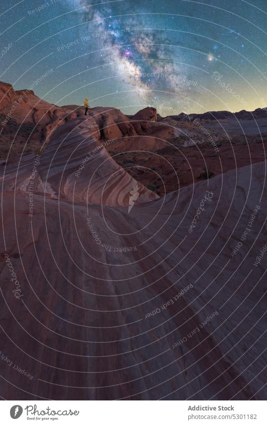 Unrecognizable traveler admiring starry sky on rocky terrain night admire milky way mountain scenic adventure nature valley of fire state park nevada usa galaxy