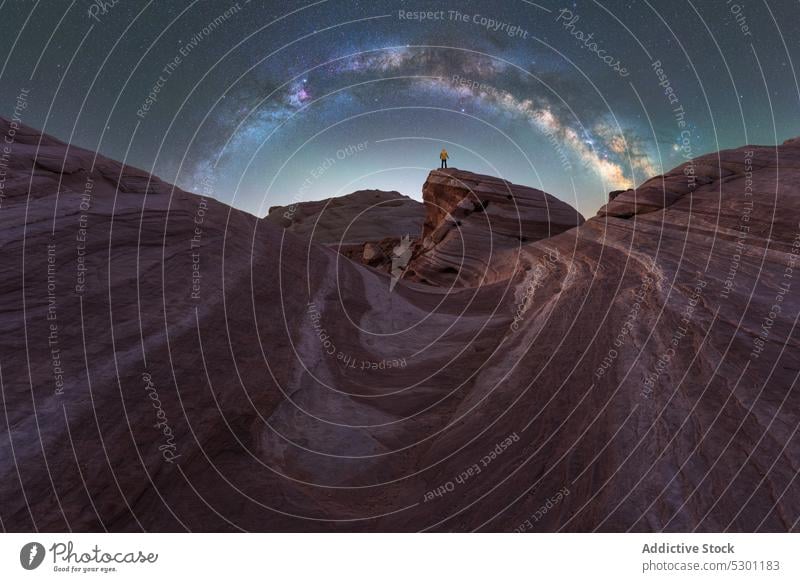 Unrecognizable traveler admiring starry sky on rocky terrain night admire milky way mountain scenic adventure nature valley of fire state park nevada usa galaxy