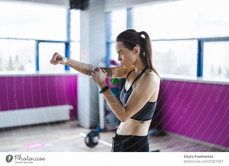 Portrait of a young woman boxing in a gym wellness wellbeing bodybuilder sporty lifting biceps muscles barbell bodybuilding people muscular adult person