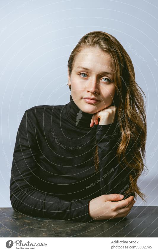 Calm woman looking at camera dreamy model turtleneck carefree lean on hand portrait appearance style studio calm long hair female young charming personality