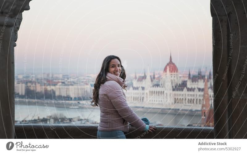 Happy woman standing on arched bridge street cityscape cheerful building architecture classic smile female budapest happy hungary urban style young positive