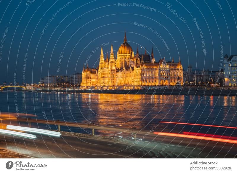 Old city with classic buildings and royal castle river dome palace architecture cityscape night illuminated arched old historic shore