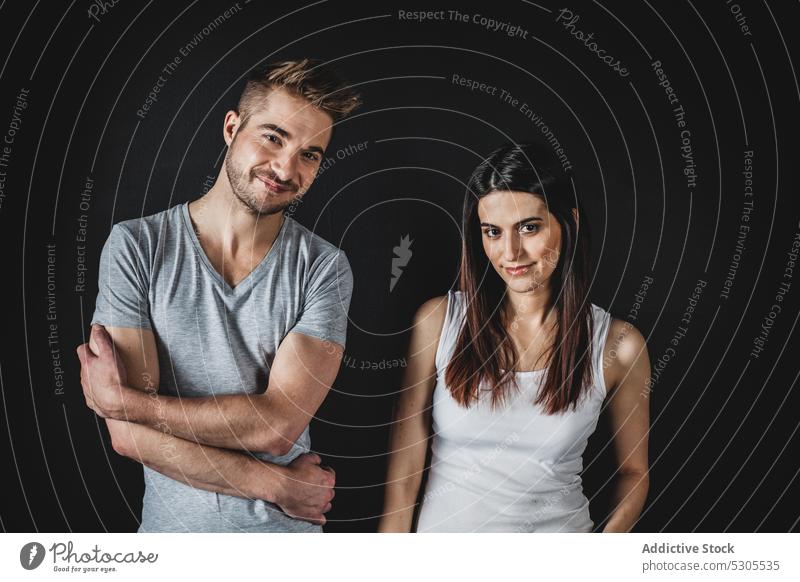 Couple posing in studio couple love together man woman relationship happy smiling casual young style tender care gentle cheerful joy pleasure glad standing